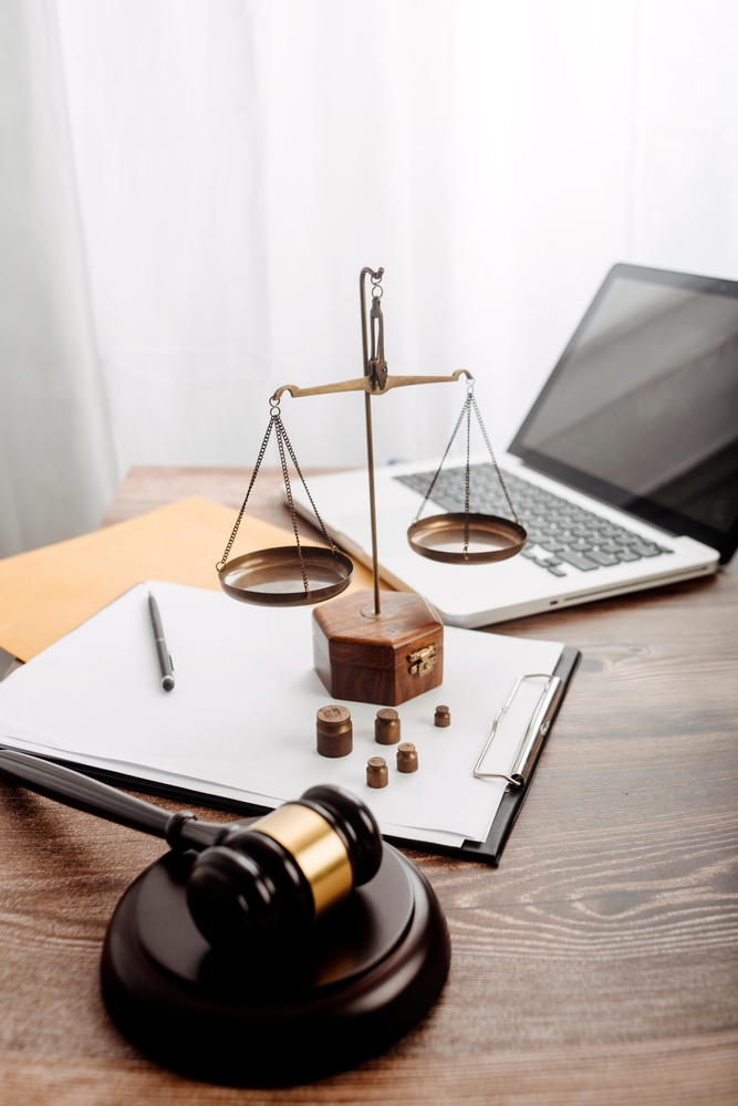 Scales of justice and gavel on a law firm desk