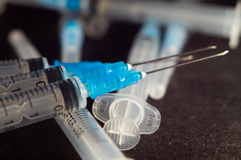 A close-up photo of a set of syringes on a black surface